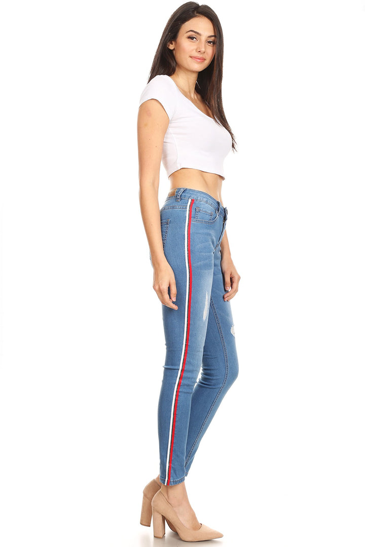 Distressed denim skinny jean with side trim and pockets